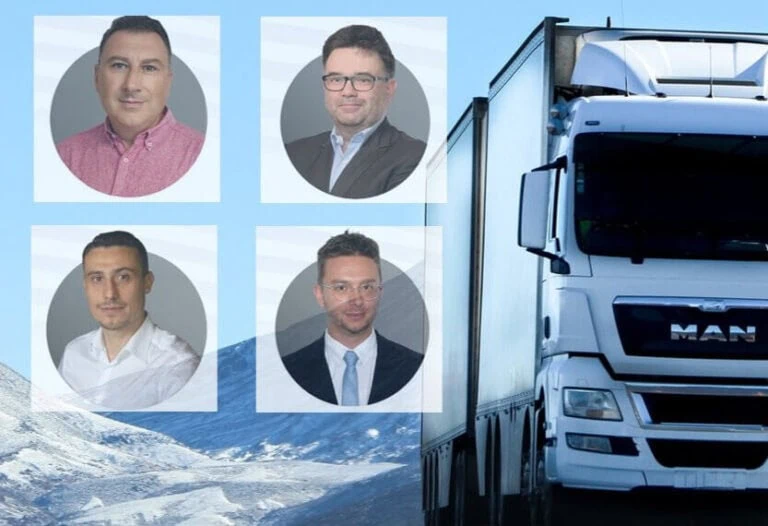 Truck and four Invoitix employees discussing road transport and factoring services