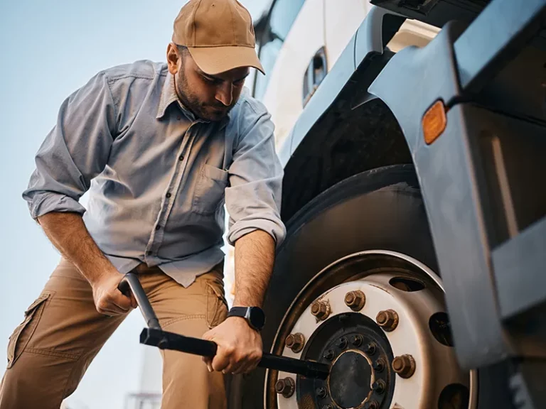 truck driver is changing truck tire depicting why tires are key factor for transport companies